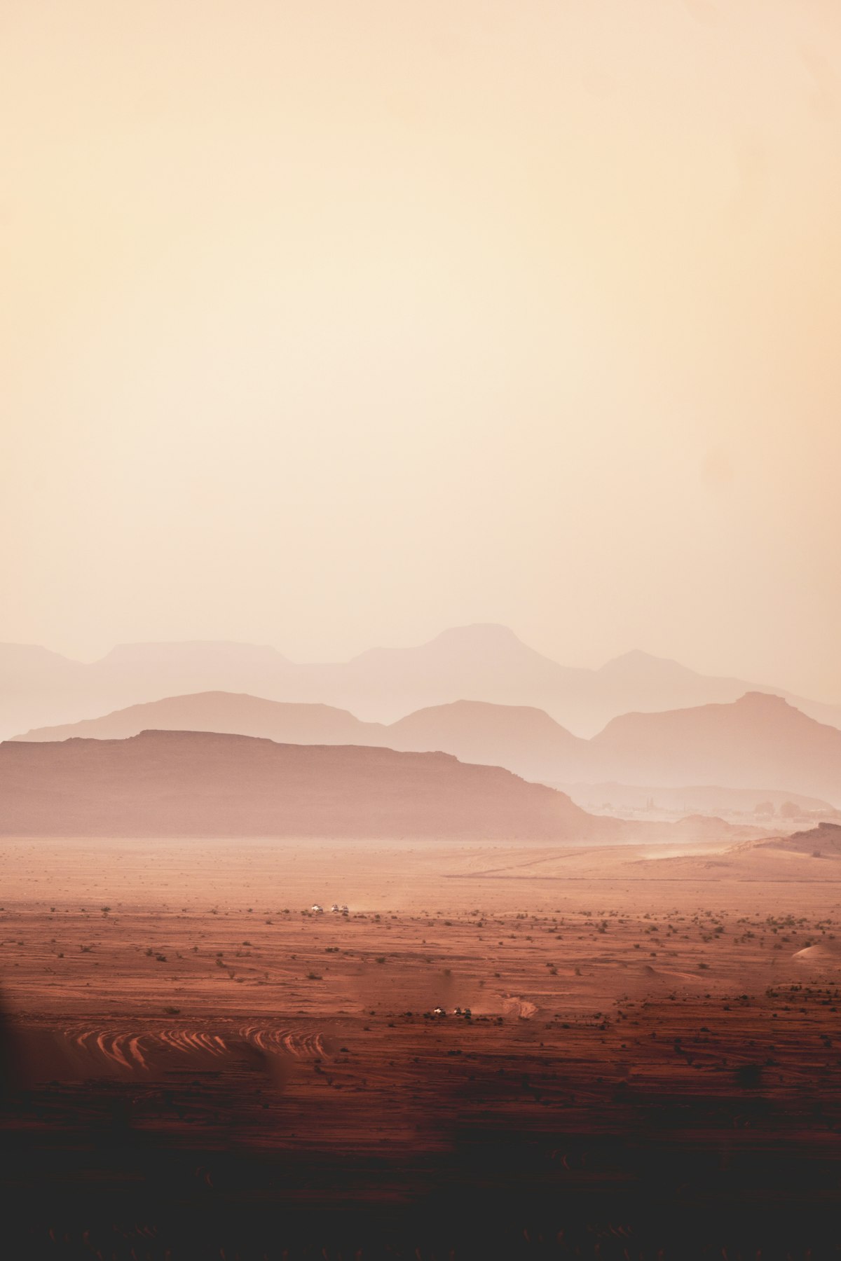 Layered red desert mountains at dusk in Wadi Rum, Jordan — a classic day trip from Aqaba