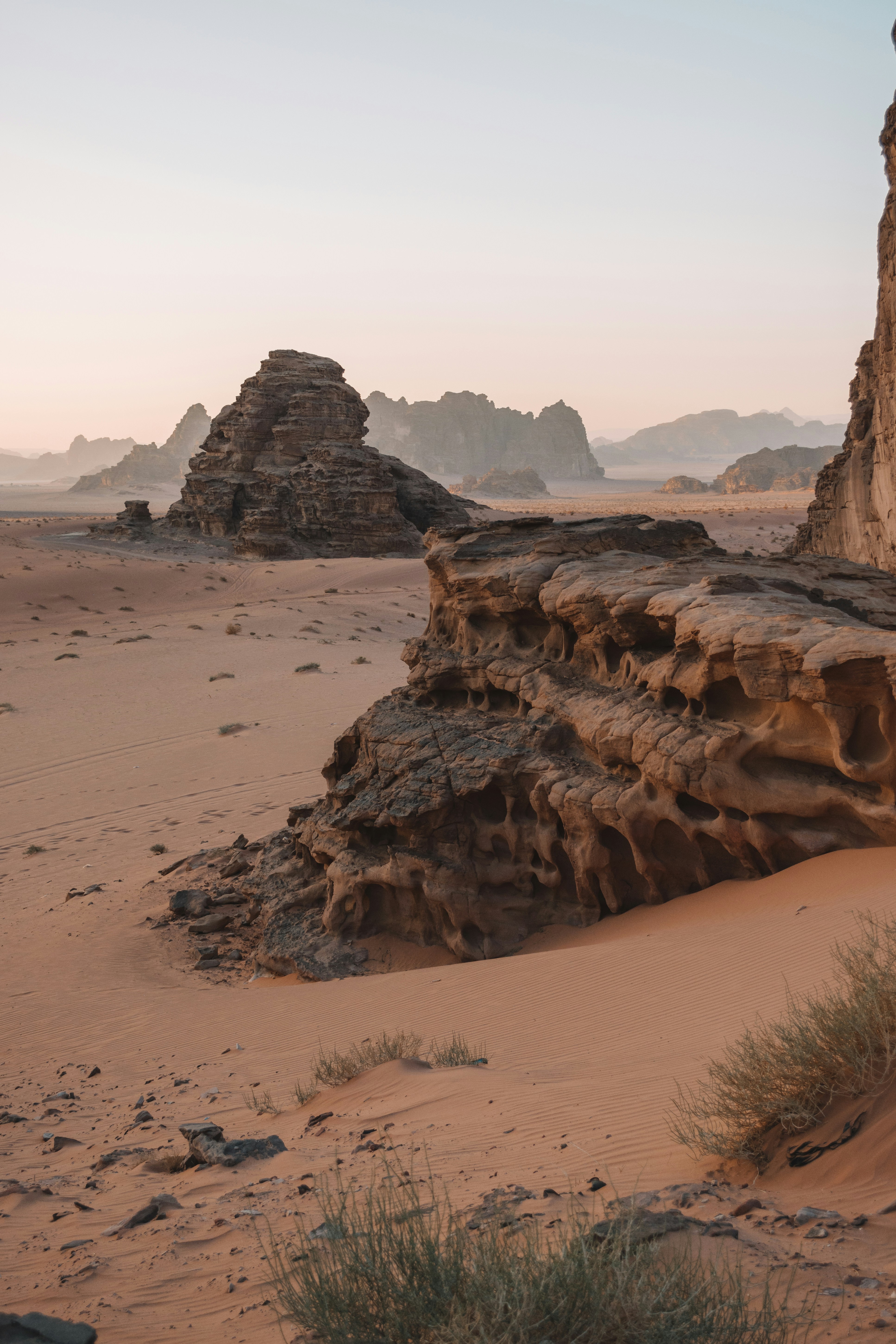 Red sandstone rock formations in the Wadi Rum desert landscape at dusk