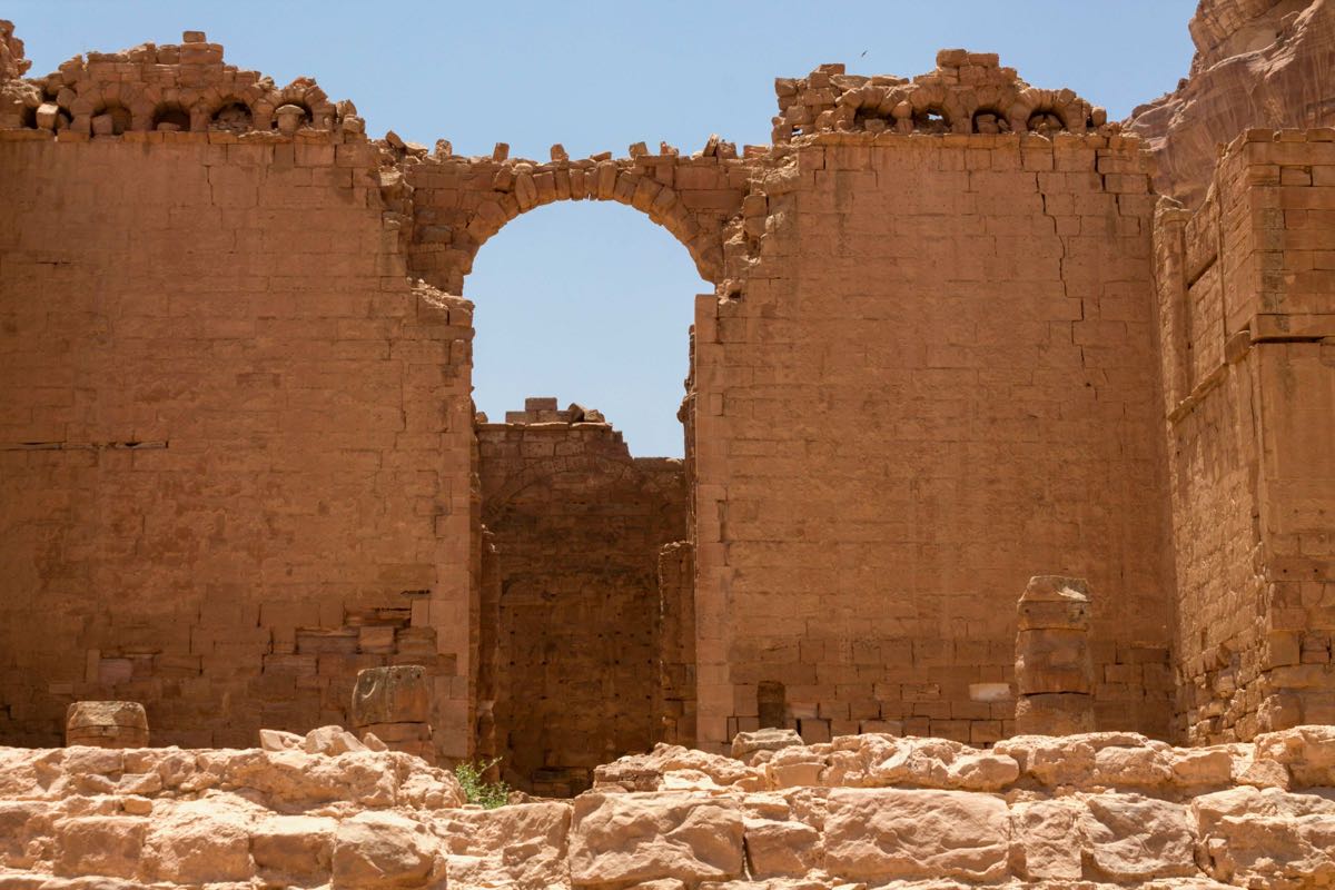 Ruined sandstone archway within a Jordanian castle, showing medieval military architecture