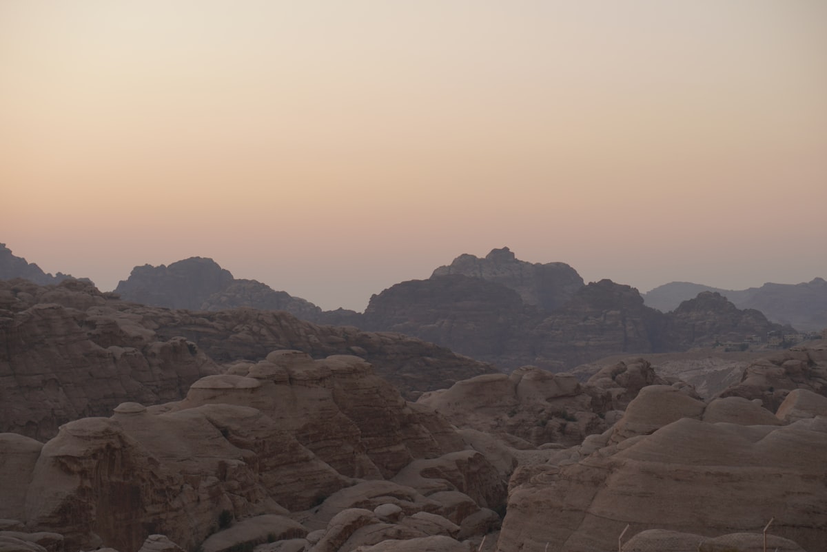 Layered sandstone mountains at dusk in the southern Jordan highlands near the Dana Biosphere Reserve