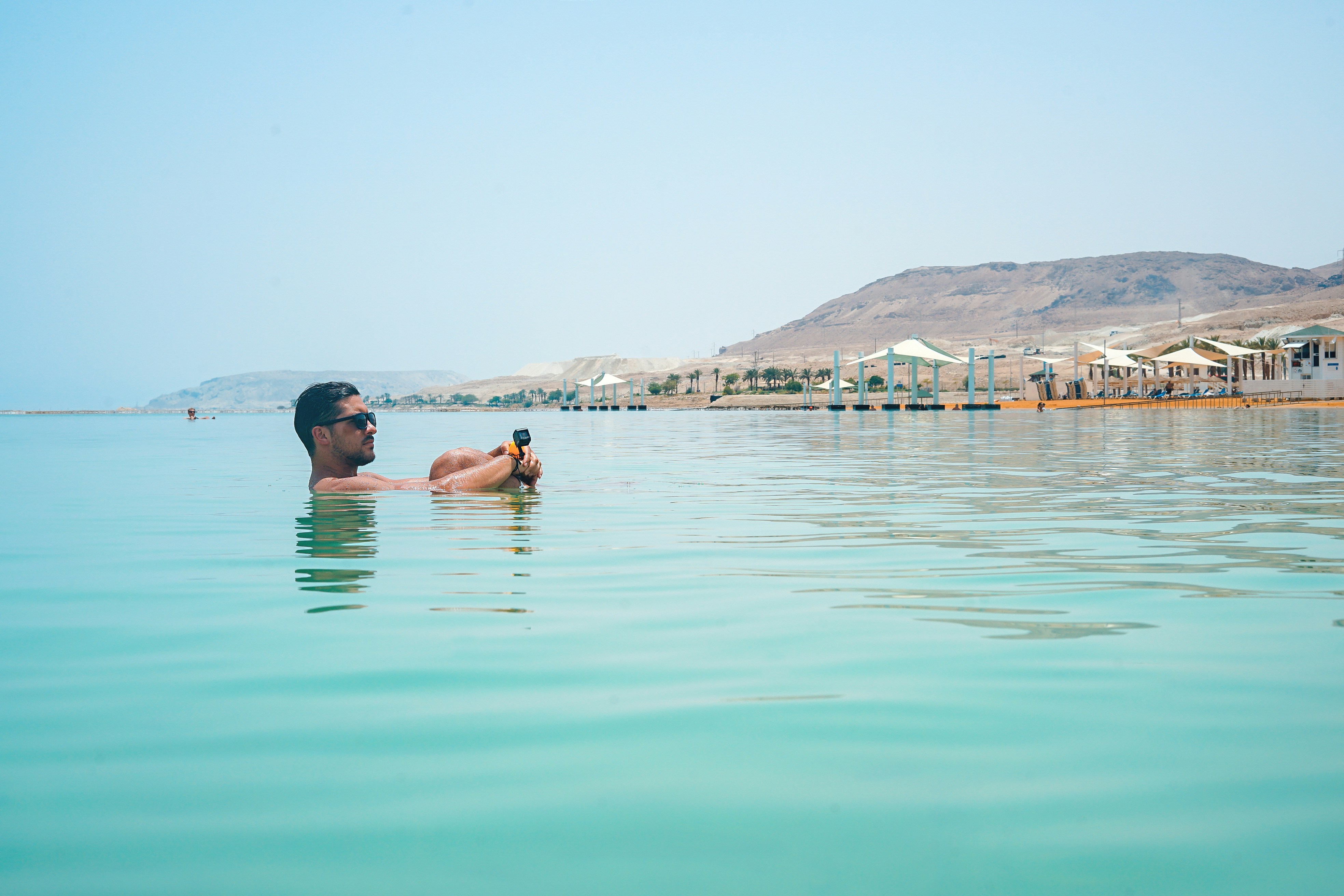 Visitor floating in the salt-rich waters of the Dead Sea, Jordan