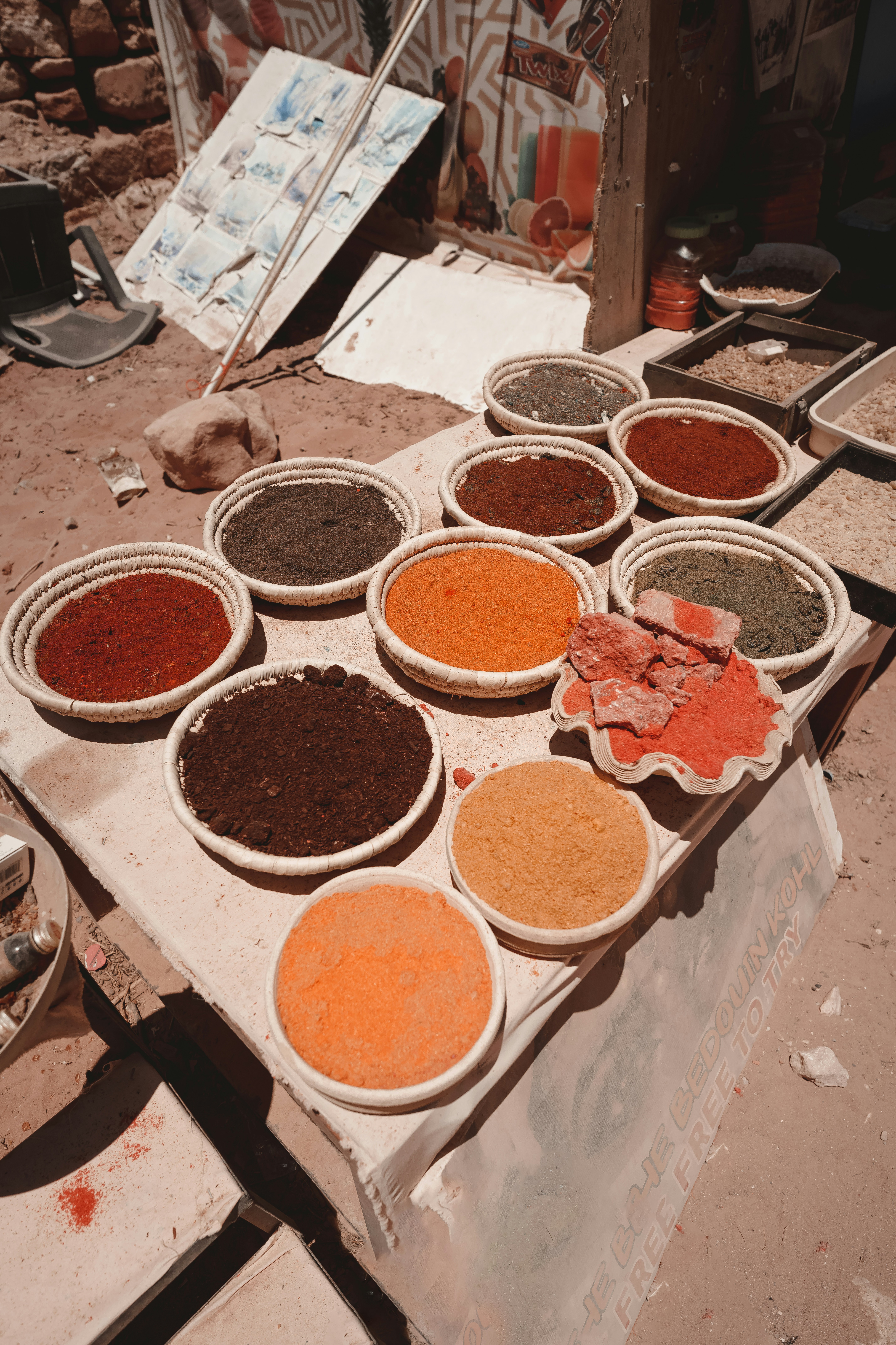 Bowls of colourful ground spices on a market table in Petra, Wadi Musa, Jordan