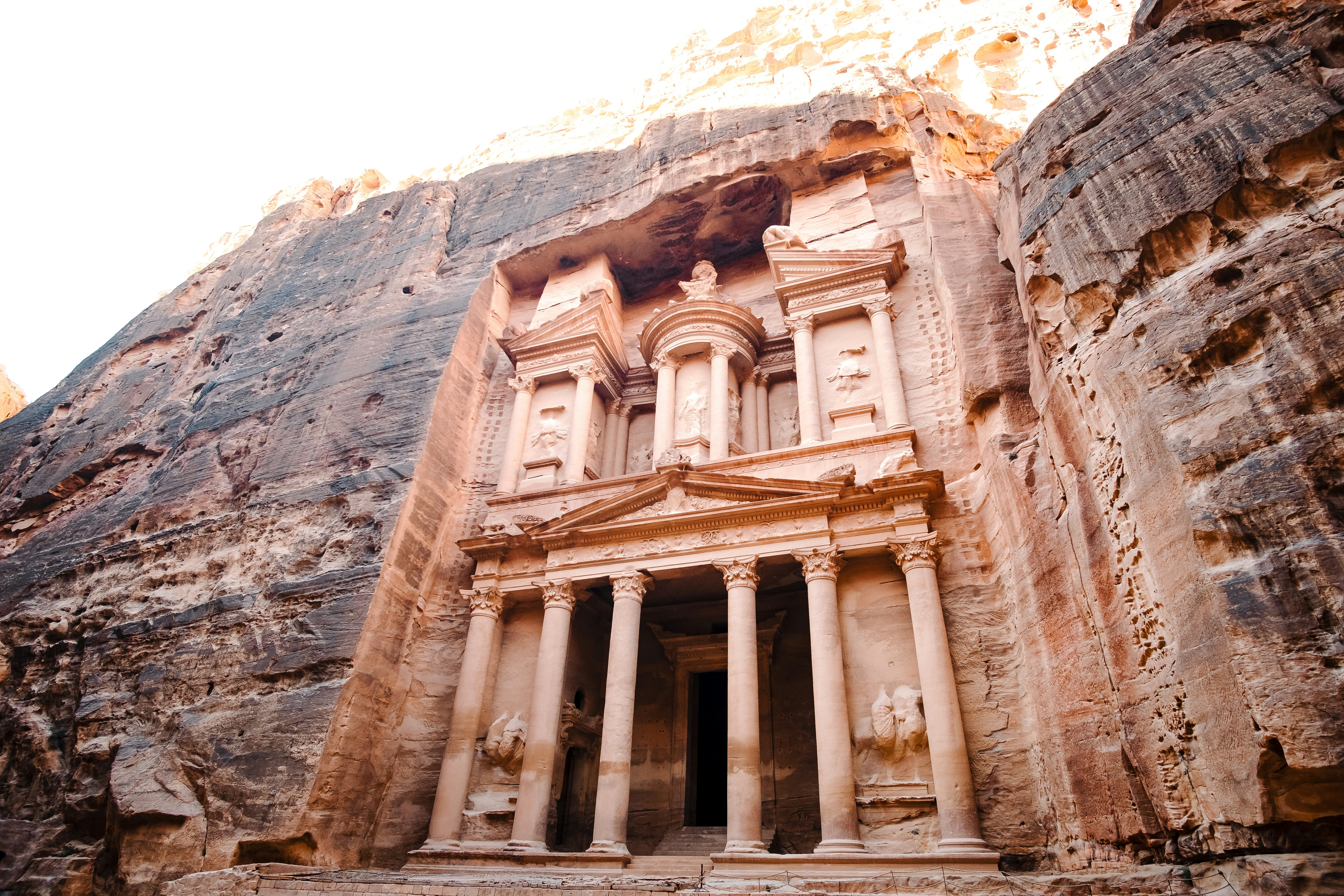 Petra Treasury carved into rose-red sandstone cliffs in Jordan