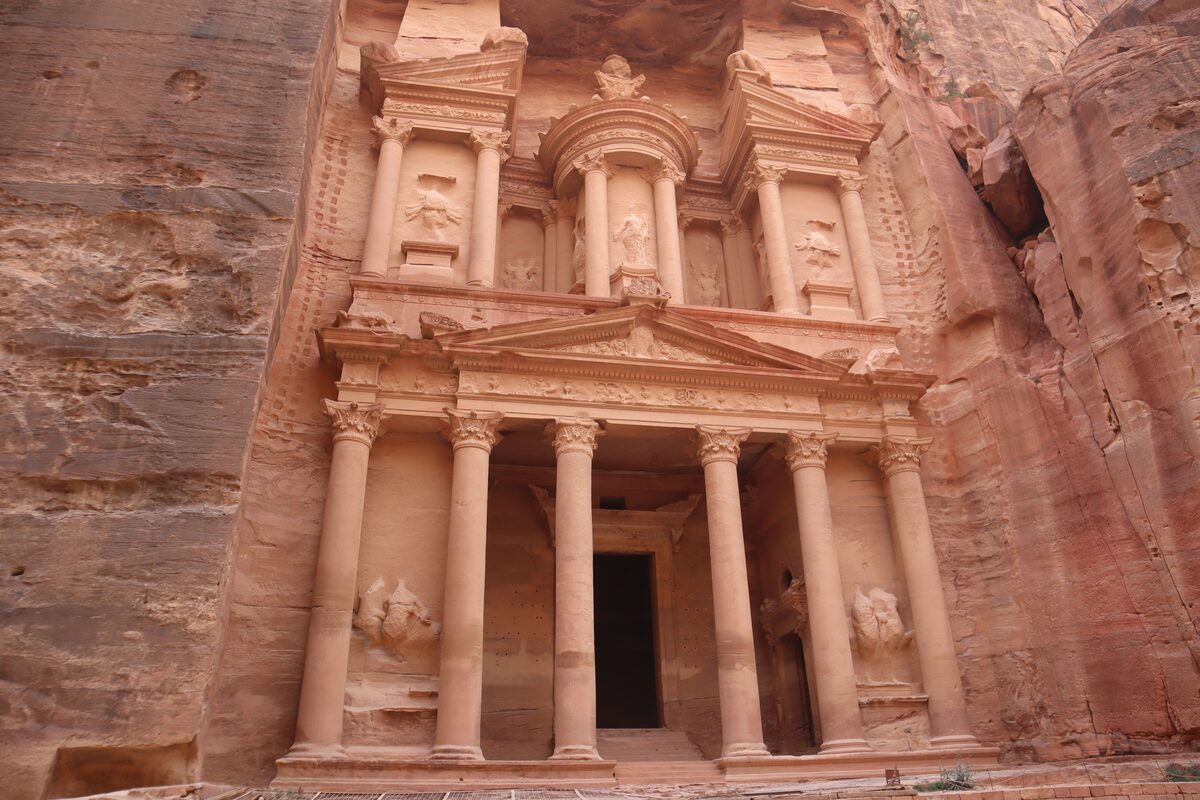 The Treasury at Petra carved into rose-red sandstone cliffs, Jordan