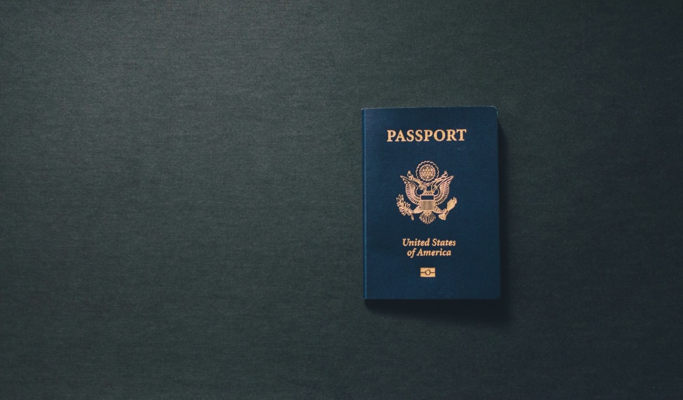 A blue passport book on a dark surface — essential travel document for Jordan