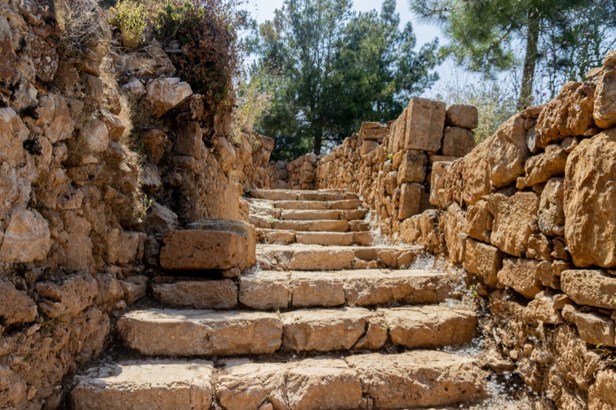Stone walls and towers of Kerak Crusader Castle rising above the plateau town of Karak, Jordan
