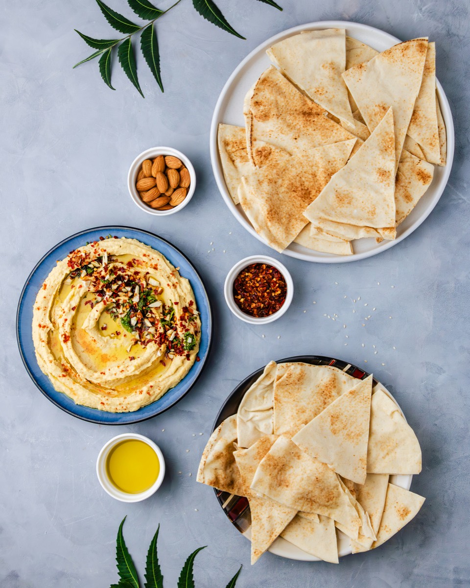 Traditional Jordanian mansaf rice dish with lamb and yoghurt sauce served on a large platter