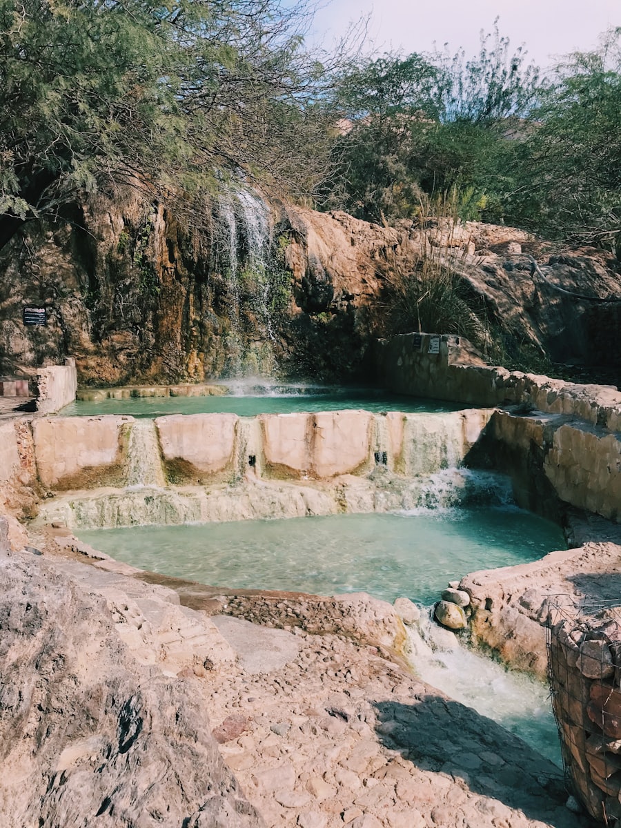 Thermal pool with cascading waterfall at Ma'in Hot Springs, Jordan
