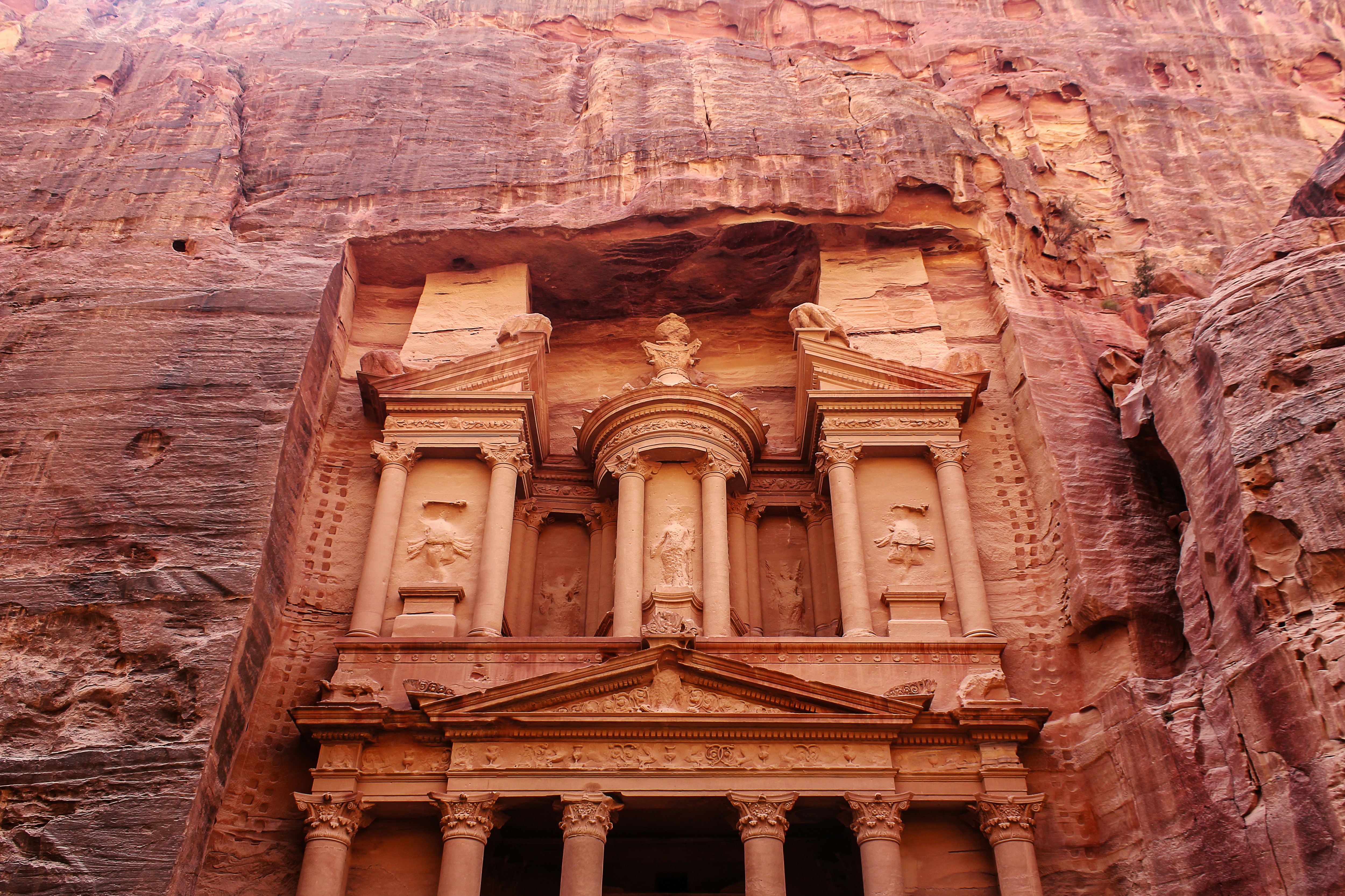 The Treasury (Al-Khazneh) at Petra carved into rose-red sandstone cliffs at the end of the Siq canyon, Jordan