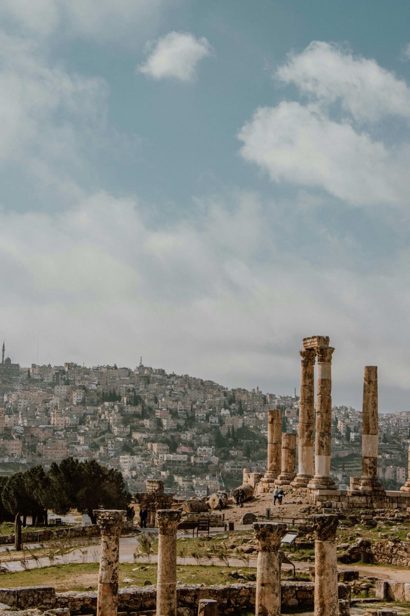 Black basalt columns and ancient ruins of the Decapolis city of Gadara at Umm Qais, Jordan, with views toward the Sea of Galilee